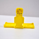 Yellow mobile holder for wall socket.